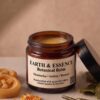 Earth & Essence Botanical Balm in an amber glass jar with calendula and rosemary